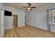 Bedroom featuring wood floors, a ceiling fan, and doorways to multiple rooms at 39 Drayton St, Clayton, NC 27527