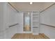 Well-organized walk-in closet with shelving, hanging rods, and a view to another room at 39 Drayton St, Clayton, NC 27527