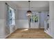 Dining room with hardwood floors, paneled walls, and modern light fixture at 39 Drayton St, Clayton, NC 27527