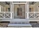 Welcoming front entrance with a screen door, ceiling fans and outdoor lighting at 39 Drayton St, Clayton, NC 27527