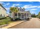 Inviting two-story home with a large, covered porch and lush green lawn at 39 Drayton St, Clayton, NC 27527