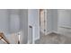 Upstairs hallway with carpet and grey walls that leads to rooms with doors and white trim at 39 Drayton St, Clayton, NC 27527