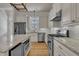 Modern kitchen featuring stainless steel appliances, granite countertops, and wood floors at 39 Drayton St, Clayton, NC 27527