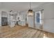 Bright, open kitchen with white cabinets, stainless steel appliances, and wood floors at 39 Drayton St, Clayton, NC 27527