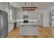 Spacious kitchen with a center island, granite countertops, and modern appliances at 39 Drayton St, Clayton, NC 27527
