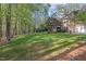 This vast backyard features mature trees, lush green grass, a long driveway, and a secluded setting at 3928 White Chapel Way, Raleigh, NC 27615