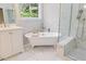 Bright bathroom with marble tile, a soaking tub, and a separate shower with a bench at 3928 White Chapel Way, Raleigh, NC 27615