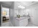 Bright bathroom features a large vanity with a white marble countertop, a tub-shower, and a toilet at 3928 White Chapel Way, Raleigh, NC 27615
