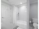 This bathroom features a tub-shower combination with white marble subway tile and white fixtures at 3928 White Chapel Way, Raleigh, NC 27615