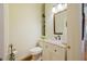 Charming powder room featuring granite countertops, a decorative mirror, and elegant fixtures for a refined touch at 3928 White Chapel Way, Raleigh, NC 27615