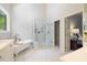 Bathroom with a walk-in shower, a soaking tub, and marble-tile flooring at 3928 White Chapel Way, Raleigh, NC 27615