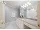 Bright bathroom features a large vanity with a white marble countertop, and a mirror with decorative lighting at 3928 White Chapel Way, Raleigh, NC 27615