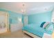 Bright bedroom with aqua walls and a chandelier at 3928 White Chapel Way, Raleigh, NC 27615