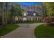 Charming two-story brick home with lush landscaping, mature trees and a curved driveway at 3928 White Chapel Way, Raleigh, NC 27615