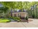 Brick home features professionally landscaped garden with mature trees at 3928 White Chapel Way, Raleigh, NC 27615