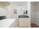 Well-organized laundry area with washer, dryer, sink, storage, and bright lighting for added convenience at 3928 White Chapel Way, Raleigh, NC 27615
