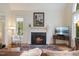 Beautiful living room featuring a cozy fireplace and natural light at 3928 White Chapel Way, Raleigh, NC 27615