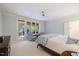 Bedroom with natural light, ceiling fan, and sunroom access with two chairs and a table at 3928 White Chapel Way, Raleigh, NC 27615