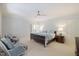 Spacious bedroom with a ceiling fan, carpeted floor, and light-blue colored walls at 3928 White Chapel Way, Raleigh, NC 27615