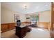 Lovely home office with wood paneled walls, large desk, and window at 3928 White Chapel Way, Raleigh, NC 27615
