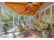 Comfortable sunroom featuring brick accents, wood ceiling with ceiling fans, and cozy seating at 3928 White Chapel Way, Raleigh, NC 27615
