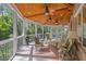 Relaxing sunroom with wood ceilings, ceiling fans, brick accents, and comfortable seating at 3928 White Chapel Way, Raleigh, NC 27615