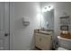 Granite vanity in bathroom paired with a toilet featuring decorative wall art and tissue basket at 408 Torwood Cir, Apex, NC 27523