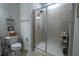 Bathroom features a glass door shower and a toilet with a basket of toilet paper at 408 Torwood Cir, Apex, NC 27523