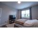 Cozy bedroom features a large window for natural light and a mounted television at 408 Torwood Cir, Apex, NC 27523