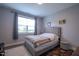Neutral bedroom featuring a comfy upholstered bed, great natural light, and modern decor at 408 Torwood Cir, Apex, NC 27523