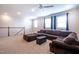 Spacious bonus room with a large sectional sofa, providing a comfortable area for relaxation and entertainment at 408 Torwood Cir, Apex, NC 27523