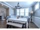 Charming dining room featuring a farmhouse-style table, bench seating, and decorative lighting at 408 Torwood Cir, Apex, NC 27523