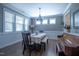Elegant dining room with a classic table setting, a bench, and natural light streaming through the windows at 408 Torwood Cir, Apex, NC 27523