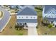 Aerial view of a well-maintained two-story home with a two-car garage and landscaped front yard at 408 Torwood Cir, Apex, NC 27523