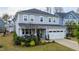 Two-story home with an attached garage, a cozy front porch, and manicured landscaping at 408 Torwood Cir, Apex, NC 27523