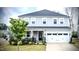Charming two-story home featuring a well-manicured lawn and an attached two-car garage at 408 Torwood Cir, Apex, NC 27523