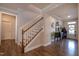 Elegant foyer featuring hardwood floors, a staircase with wooden handrail, and a stylish console table at 408 Torwood Cir, Apex, NC 27523
