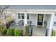 Charming front porch featuring a cozy seating area and decorative wreath on the front door at 408 Torwood Cir, Apex, NC 27523