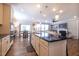 Open-concept kitchen with a breakfast bar, seamlessly connected to the living area at 408 Torwood Cir, Apex, NC 27523
