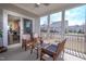 Relaxing screened porch with comfortable seating, offering views of the neighborhood and access to the home's interior at 408 Torwood Cir, Apex, NC 27523