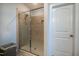 Walk-in shower featuring tiled walls and a glass door, offering a spa-like experience in the bathroom at 408 Torwood Cir, Apex, NC 27523