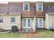 Back exterior of townhouse featuring double doors that lead to a wood deck at 4816 Blue Bird Ct # B, Raleigh, NC 27606