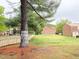 Large backyard with a wood fence and a large tree providing shade and privacy at 4816 Blue Bird Ct # B, Raleigh, NC 27606
