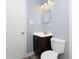 Cozy bathroom featuring a dark wood vanity, mirror, and tile flooring at 4816 Blue Bird Ct # B, Raleigh, NC 27606