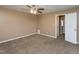 Bedroom with tan carpet, neutral paint, and a doorway leading to another room at 4816 Blue Bird Ct # B, Raleigh, NC 27606