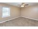 Bright bedroom featuring neutral paint, carpet, a window, and a ceiling fan at 4816 Blue Bird Ct # B, Raleigh, NC 27606