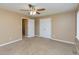 Bedroom features neutral walls and carpet, a ceiling fan, closet doors and a window at 4816 Blue Bird Ct # B, Raleigh, NC 27606