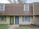 Charming townhouse exterior featuring muted siding, colorful doors and shutters, and a shingle roof at 4816 Blue Bird Ct # B, Raleigh, NC 27606