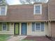 Front exterior of townhouses with green and blue doors and matching shutters at 4816 Blue Bird Ct # B, Raleigh, NC 27606