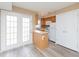 Eat-in kitchen featuring updated appliances, custom cabinetry, and access to living room and patio at 4816 Blue Bird Ct # B, Raleigh, NC 27606